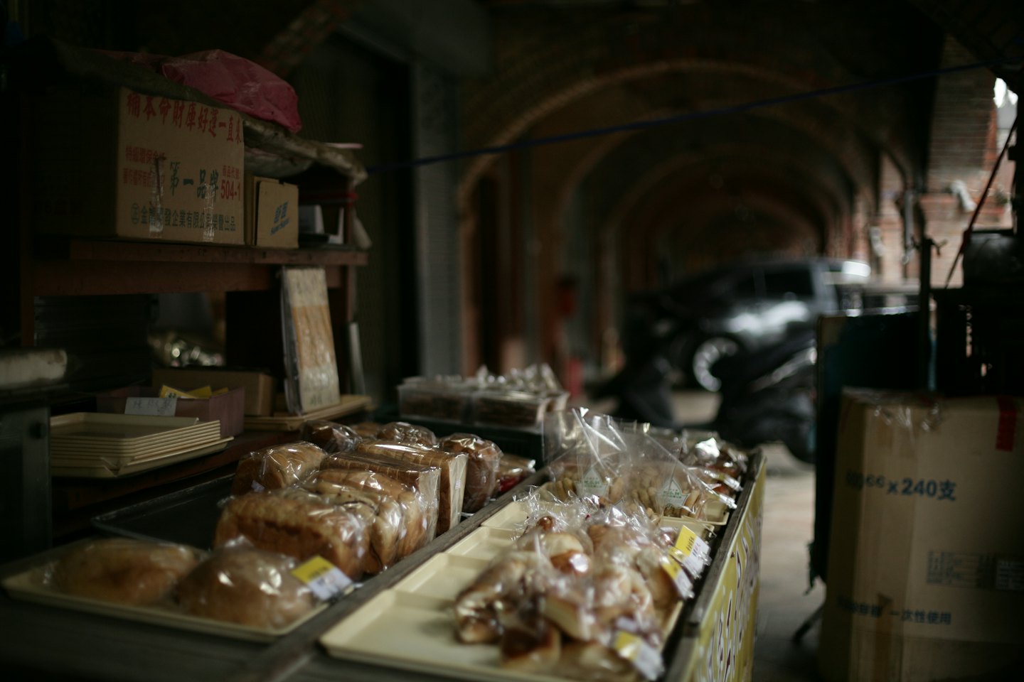 Assorted fresh pastries and bread displayed in a market stall.